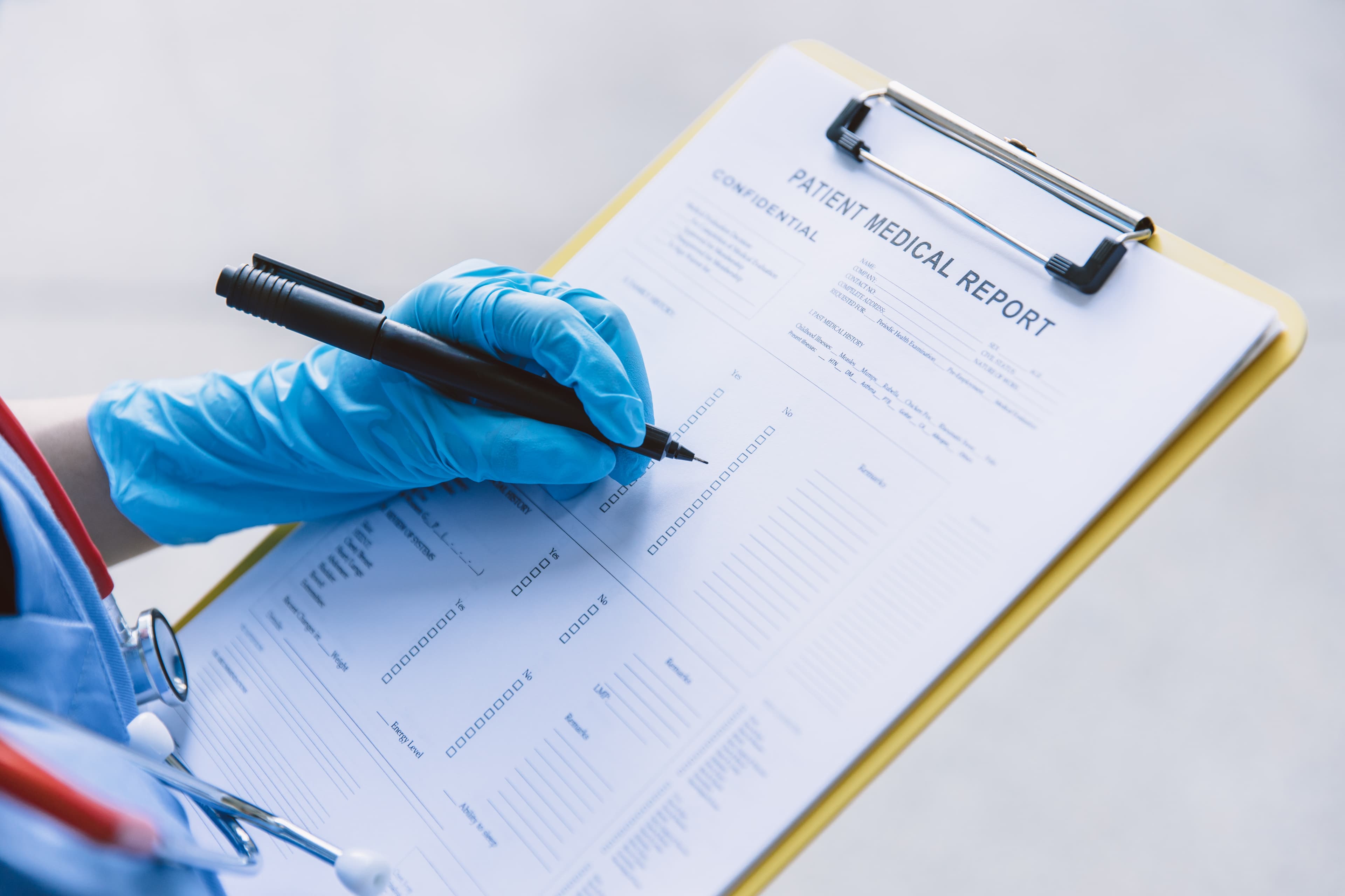 Hospital staff documenting patient medical report on clipboard
