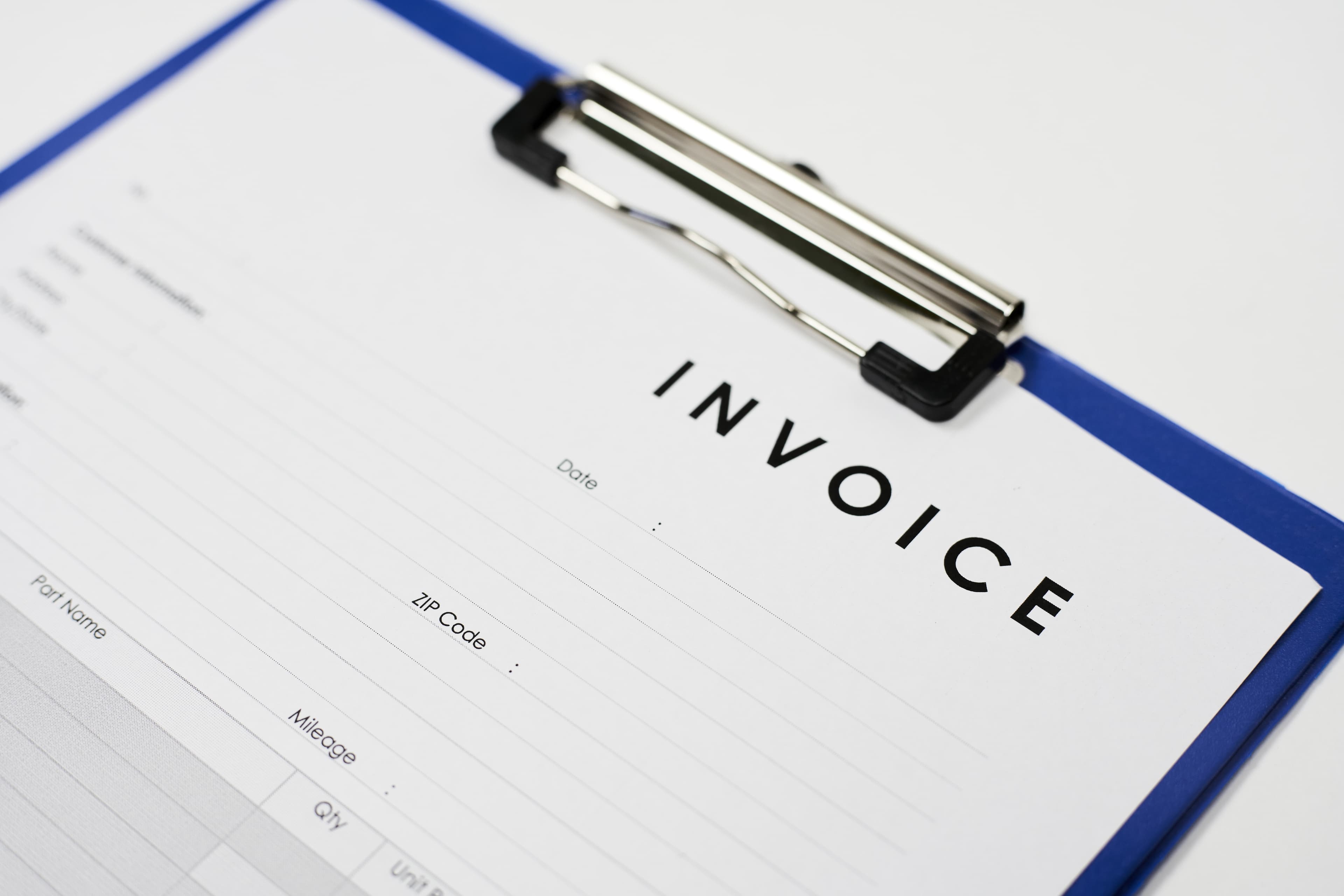 Close-up of invoice document on clipboard for billing processing