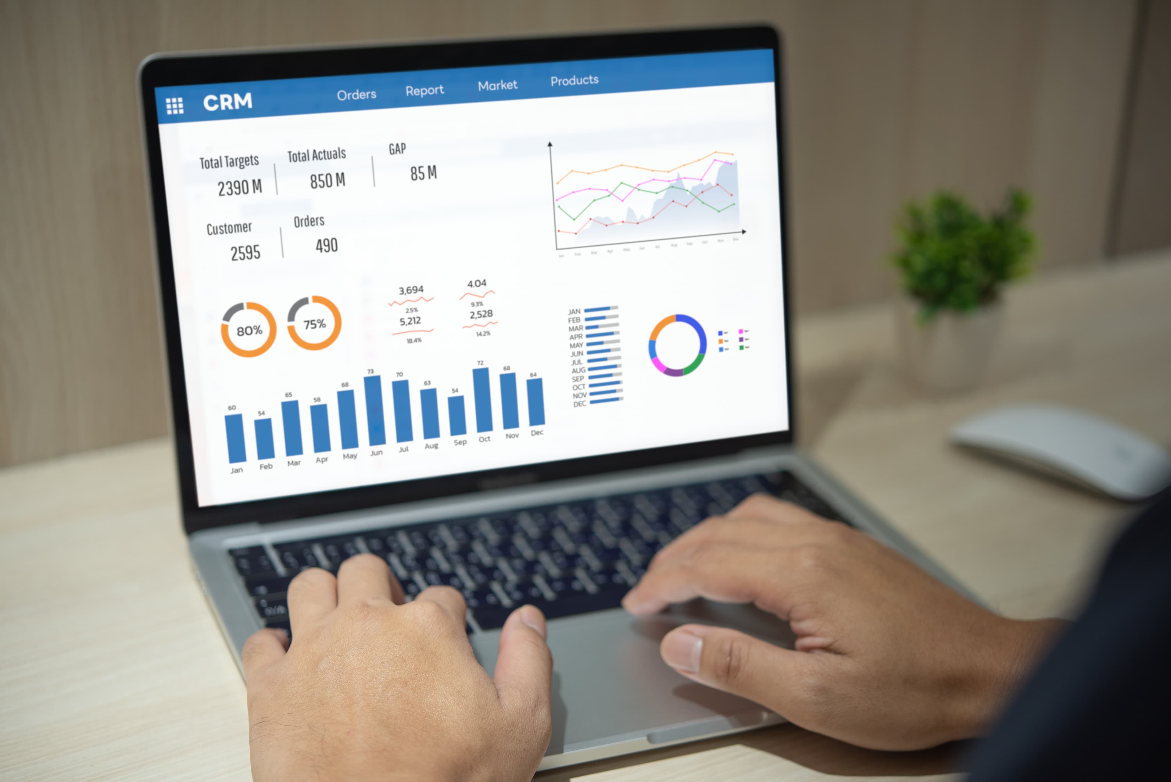 Professional analysing CRM reporting dashboard with graphs and charts on laptop